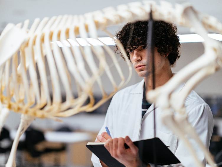 A person in a lab coat writing on a clipboard

AI-generated content may be incorrect.